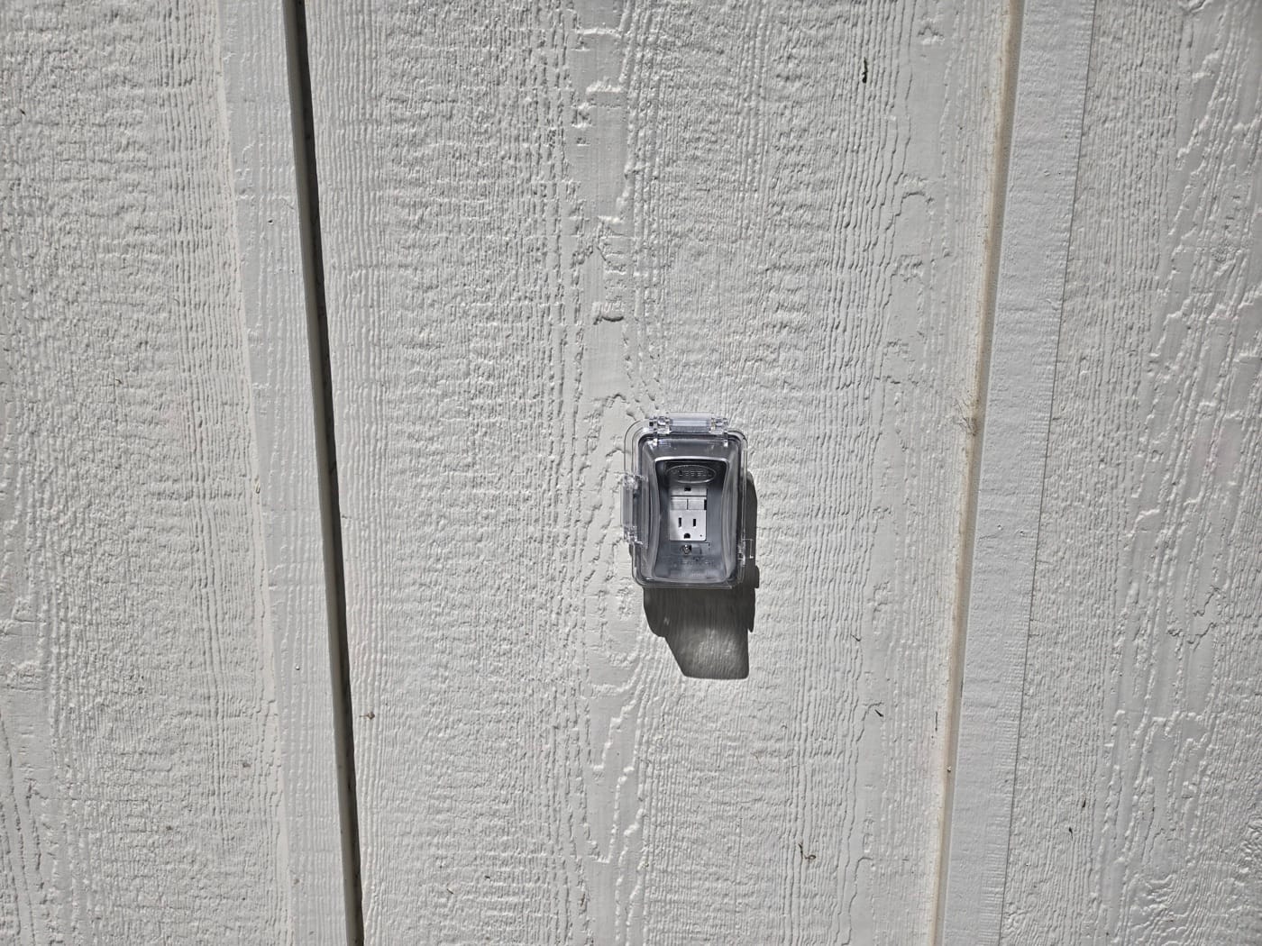 Weatherproof GFCI exterior outlet installed on home siding — handyman electrical work in Salt Lake Valley UT